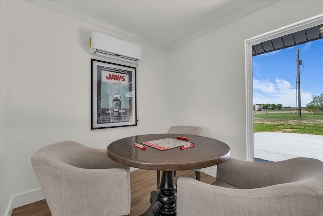 dining space with wood finished floors, ornamental molding, baseboards, and an AC wall unit