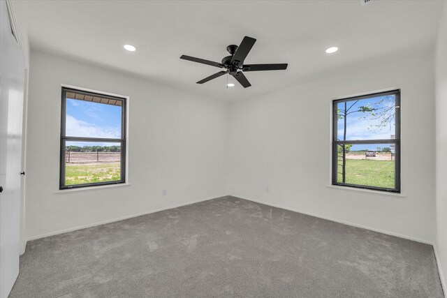 spare room with baseboards, recessed lighting, carpet, and a ceiling fan