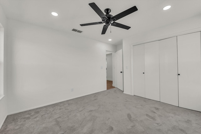 unfurnished bedroom featuring visible vents, baseboards, a closet, carpet floors, and recessed lighting