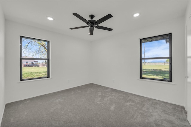 carpeted empty room featuring a healthy amount of sunlight, a ceiling fan, and recessed lighting