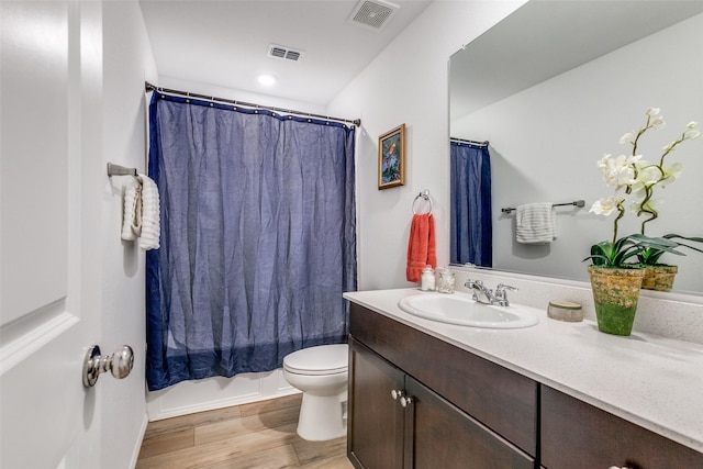 502 Cochran Dr, Princeton, TX 75407 - bathroom featuring vanity, toilet, wood finished floors, and shower / bath combination with curtain