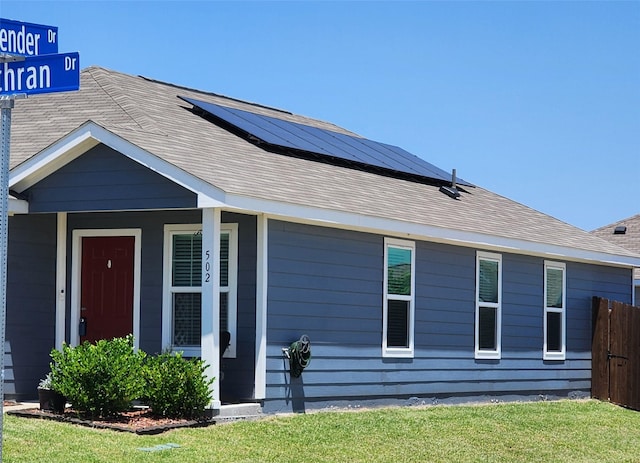 502 Cochran Dr, Princeton, TX 75407 - view of front facade with solar panels, a porch, and a shingled roof