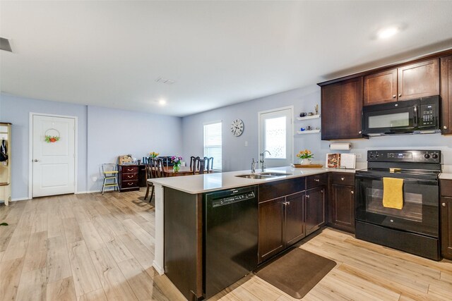 502 Cochran Dr, Princeton, TX 75407 - kitchen with black appliances, a sink, light wood finished floors, dark brown cabinetry, and recessed lighting