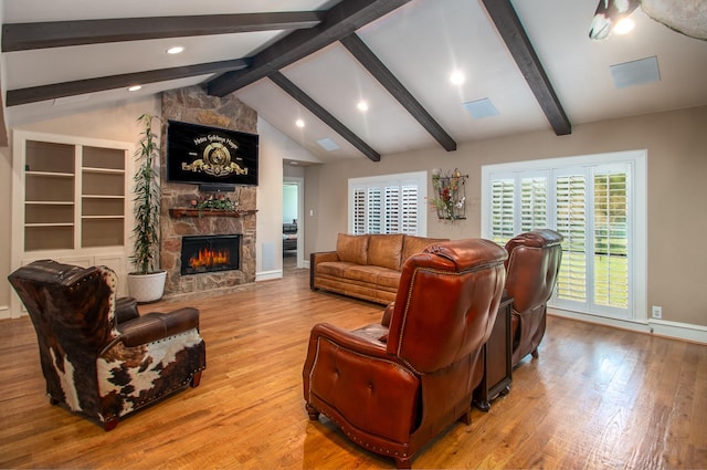 living area featuring baseboards, lofted ceiling with beams, recessed lighting, a fireplace, and wood finished floors
