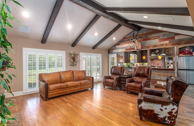 living room with recessed lighting, light wood finished floors, baseboards, and vaulted ceiling with beams