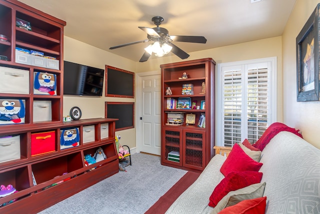 sitting room featuring a ceiling fan