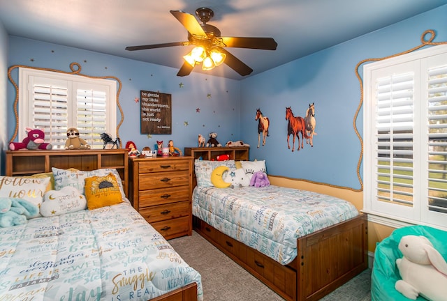 bedroom featuring ceiling fan and carpet