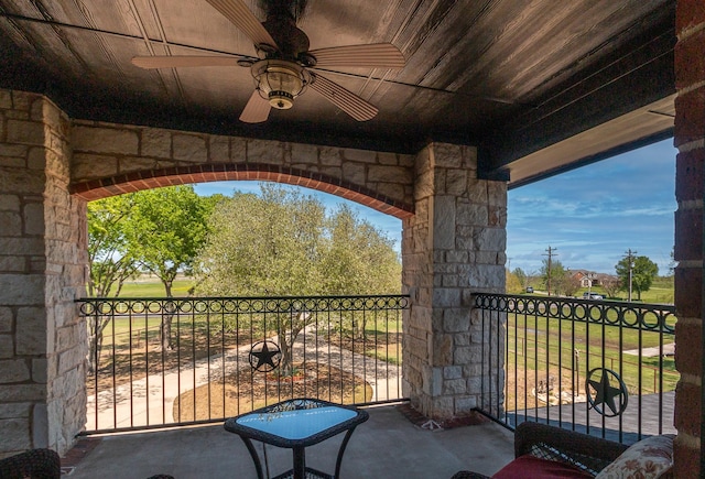 view of patio / terrace with a ceiling fan and a balcony