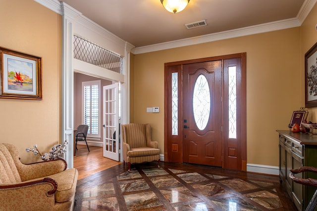 entrance foyer featuring french doors, baseboards, ornamental molding, and visible vents