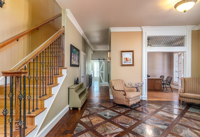interior space with crown molding, baseboards, a wealth of natural light, and a barn door