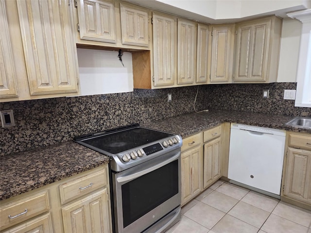 kitchen with light tile patterned floors, stainless steel electric range oven, dishwasher, a sink, and backsplash