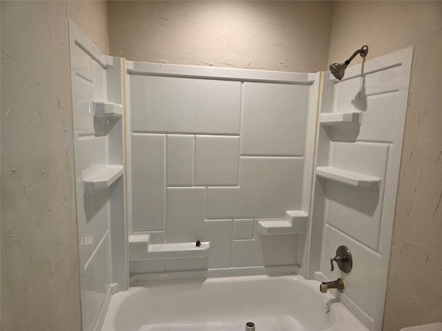 full bathroom featuring bathing tub / shower combination and a textured wall