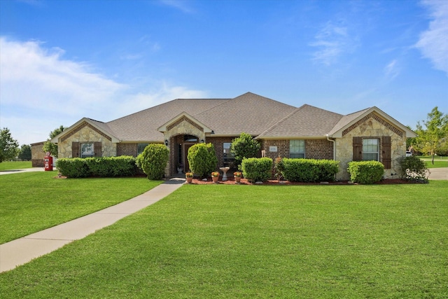 2016 Big Springs Dr, Joshua, TX 76058 - view of front facade featuring stone siding, a front lawn, a shingled roof, and brick siding