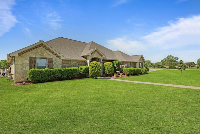 2016 Big Springs Dr, Joshua, TX 76058 - view of front facade featuring stone siding, a front yard, and roof with shingles