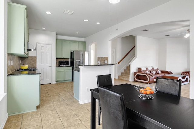 dining area featuring recessed lighting, light tile patterned floors, visible vents, ceiling fan, and arched walkways