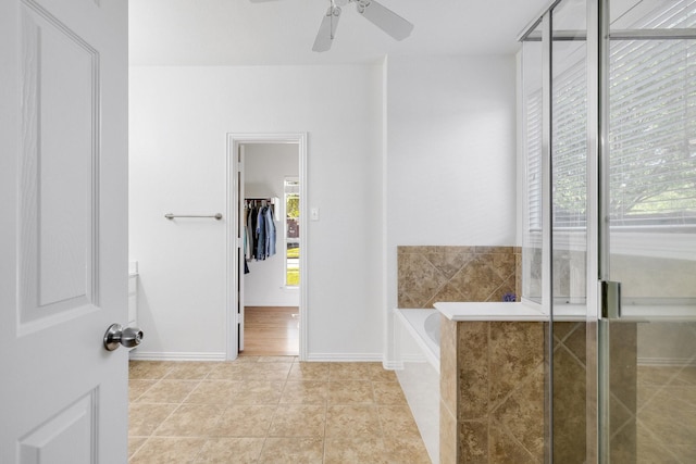bathroom featuring a ceiling fan, a garden tub, baseboards, and tile patterned flooring