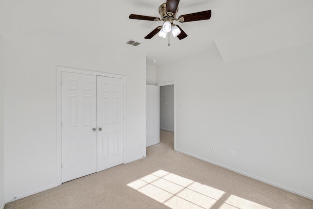 unfurnished bedroom with visible vents, a ceiling fan, a closet, and light carpet