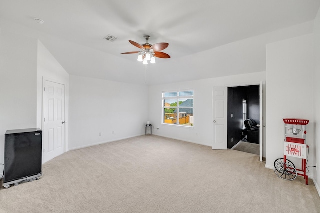 unfurnished living room featuring visible vents, ceiling fan, carpet, and baseboards