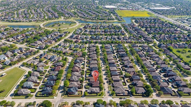 birds eye view of property featuring a water view and a residential view