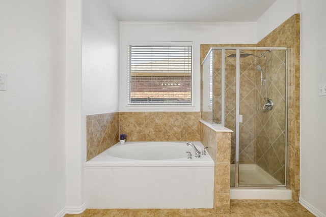 bathroom featuring a shower stall, a bath, and tile patterned flooring