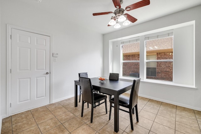 dining space with light tile patterned floors, baseboards, and a ceiling fan