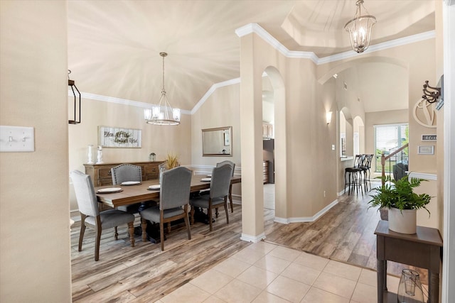 191 Cardiff Ln, Waxahachie, TX 75167 - dining area with arched walkways, an inviting chandelier, high vaulted ceiling, and wood finished floors