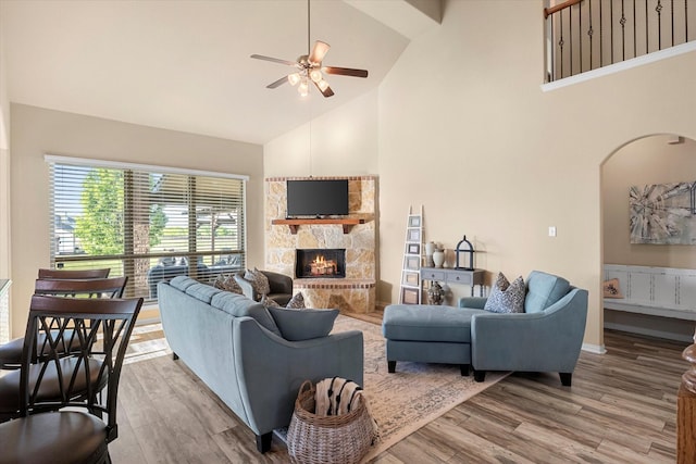 191 Cardiff Ln, Waxahachie, TX 75167 - living room with wood finished floors, high vaulted ceiling, a fireplace, arched walkways, and ceiling fan