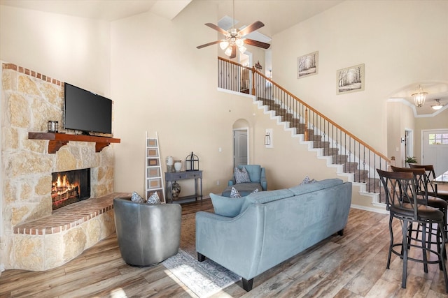191 Cardiff Ln, Waxahachie, TX 75167 - living area with wood finished floors, high vaulted ceiling, a fireplace, ceiling fan, and arched walkways