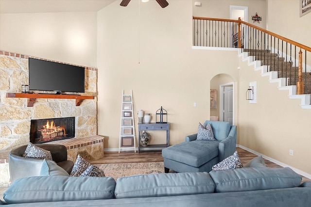 191 Cardiff Ln, Waxahachie, TX 75167 - living room with wood finished floors, high vaulted ceiling, a fireplace, arched walkways, and a ceiling fan