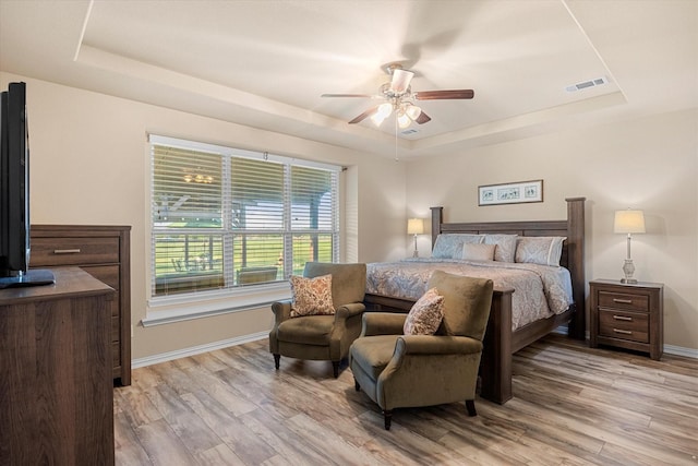 191 Cardiff Ln, Waxahachie, TX 75167 - bedroom with light wood-style floors, visible vents, baseboards, and a raised ceiling