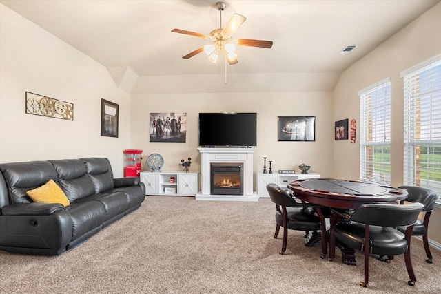 191 Cardiff Ln, Waxahachie, TX 75167 - carpeted living room with lofted ceiling, visible vents, a glass covered fireplace, and ceiling fan
