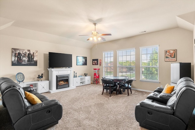191 Cardiff Ln, Waxahachie, TX 75167 - carpeted living room featuring ceiling fan, a glass covered fireplace, visible vents, and vaulted ceiling