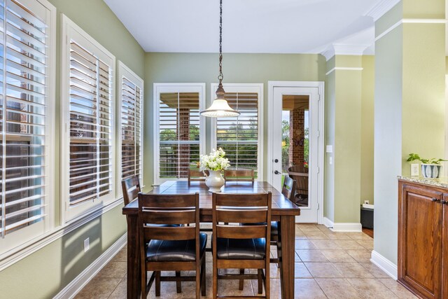dining space with light tile patterned floors and baseboards
