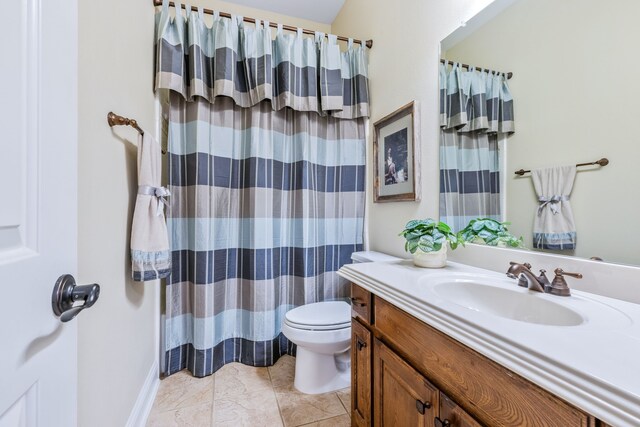 bathroom featuring toilet, vanity, and a shower with curtain