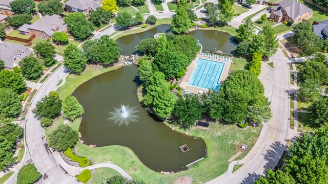 aerial view of residential area featuring a large body of water and a pool area