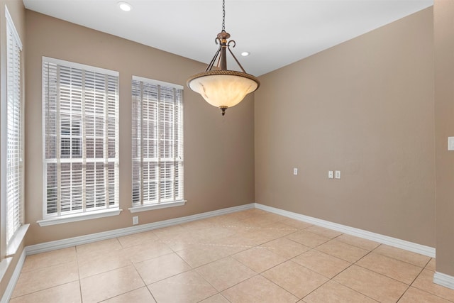 empty room with baseboards and plenty of natural light