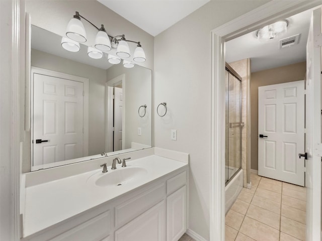full bathroom featuring vanity, baseboards, tile patterned flooring, and visible vents