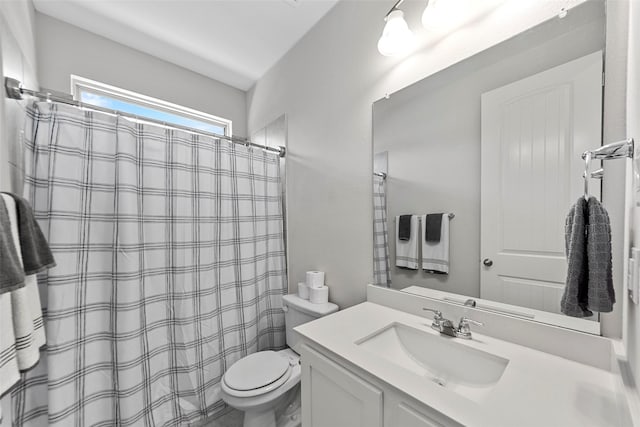 bathroom with toilet, vanity, and a shower with curtain