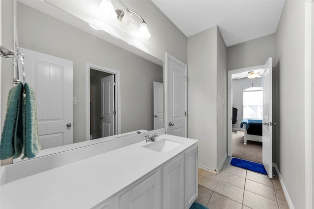 bathroom featuring ceiling fan, baseboards, tile patterned flooring, and vanity