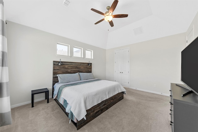 bedroom featuring visible vents, baseboards, vaulted ceiling, and light carpet