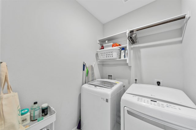 laundry room with washer and clothes dryer and laundry area