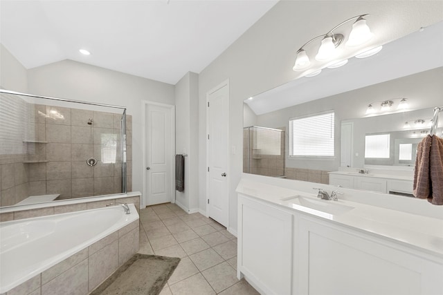 bathroom featuring a garden tub, vanity, tile patterned flooring, a stall shower, and lofted ceiling