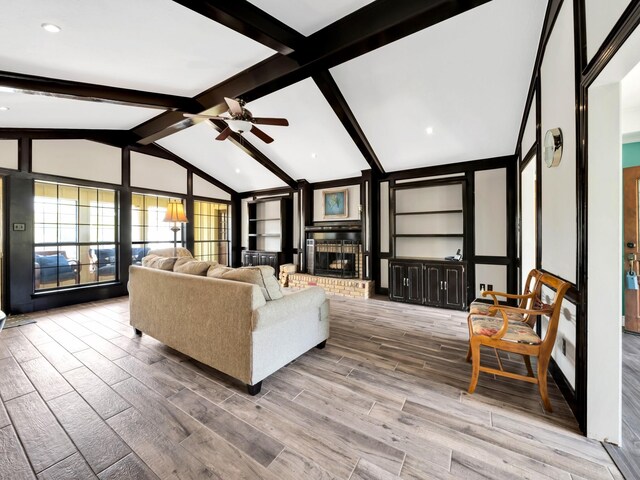 1770 Plummer Dr, Rockwall, TX 75087 - living room with a fireplace, a ceiling fan, and wood finished floors