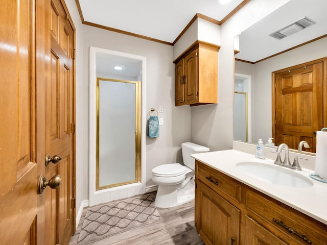 1770 Plummer Dr, Rockwall, TX 75087 - full bathroom featuring a shower stall, vanity, crown molding, wood finished floors, and toilet