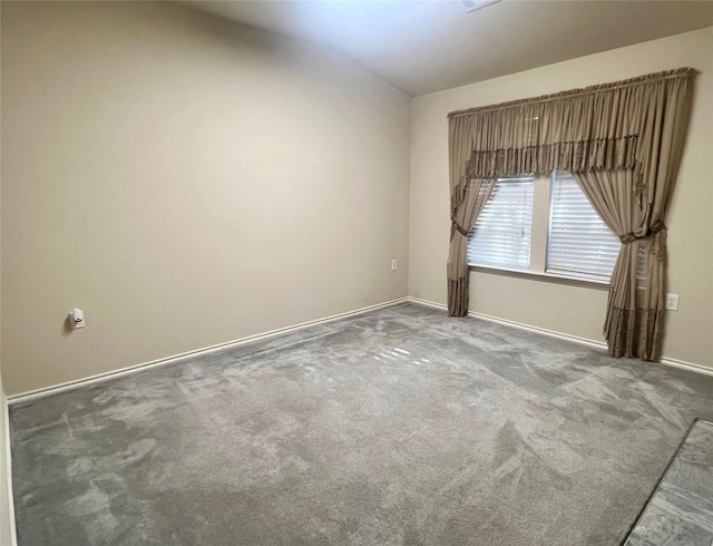 112 Jimmie Birdwell Blvd, Ferris, TX 75125 - spare room featuring carpet floors, baseboards, and vaulted ceiling