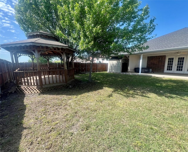 112 Jimmie Birdwell Blvd, Ferris, TX 75125 - view of yard featuring a gazebo, french doors, a fenced backyard, an outdoor structure, and a storage unit