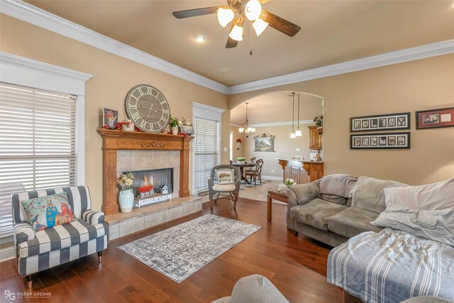 306 N Hampton St, Haughton, LA 71037 - living room featuring a ceiling fan, wood finished floors, crown molding, arched walkways, and a tiled fireplace