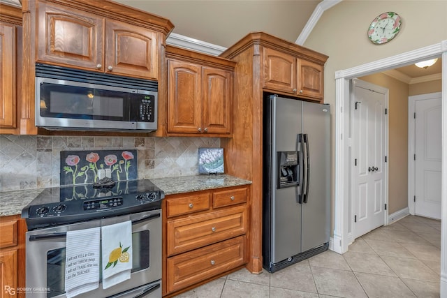 306 N Hampton St, Haughton, LA 71037 - kitchen with appliances with stainless steel finishes, crown molding, light tile patterned flooring, decorative backsplash, and light stone countertops