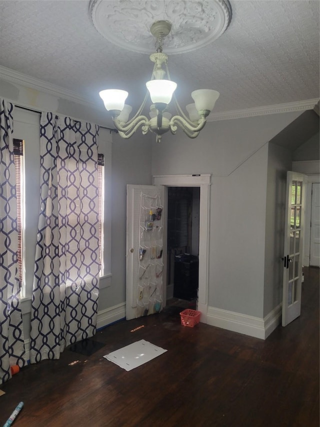 409 Forest Ave, Shreveport, LA 71104 - unfurnished dining area with wood finished floors, ornamental molding, a chandelier, and a textured ceiling