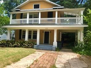 409 Forest Ave, Shreveport, LA 71104 - view of front of home with a balcony, a porch, and a carport